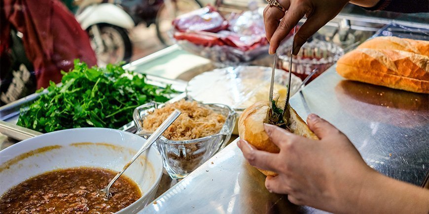 Woman making a Banh Mi sandwich in Ho Chi Minh City, Vietnam