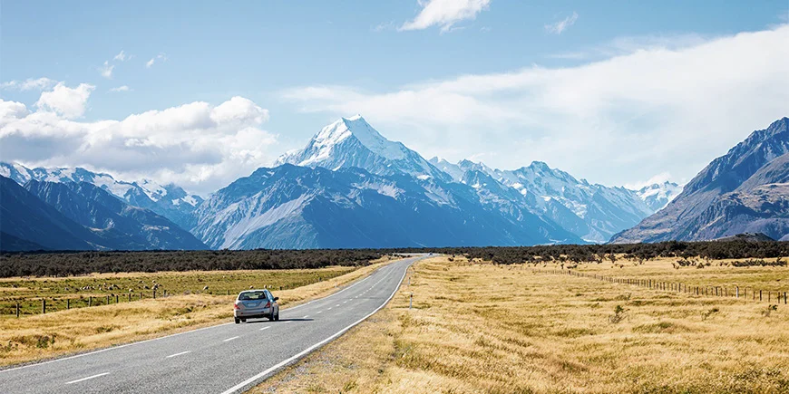 Car driving through beautiful landscapes in New Zealand