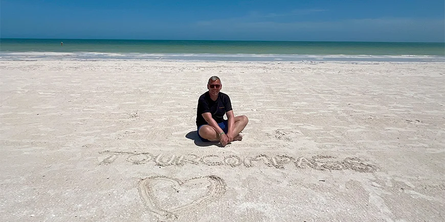 Tom sitting in the sand on Isla Holbox in Mexico