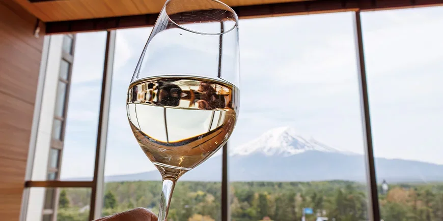 A glass of wine with a view of Mount Fuji