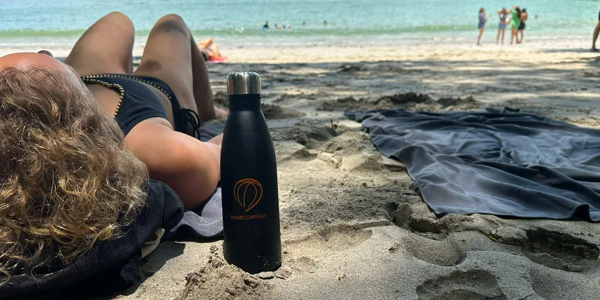 Woman lying in the sand on a sunny day on a beach in Costa Rica.