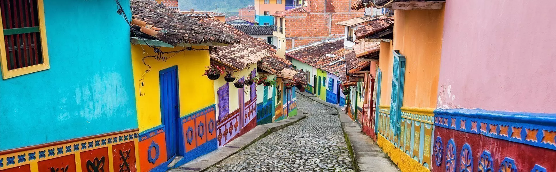 Colourful colonial houses on a cobbled street in Guatape, Antioquia in Colombia
