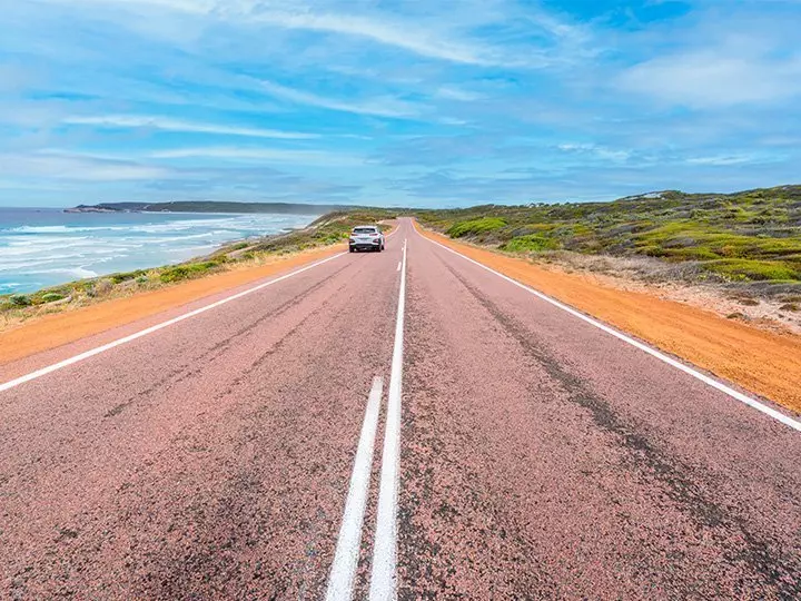 Car travelling on the Great Ocean Road in Western Australia