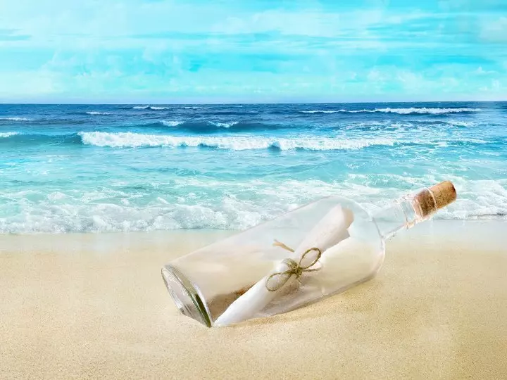 Message in a bottle at the water's edge