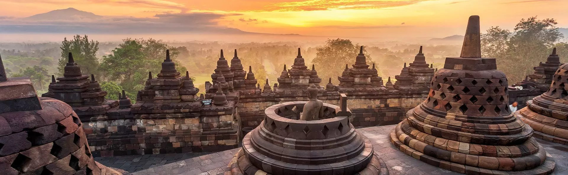 Dramatic and colourful sunrise seen from Borobudur, Java