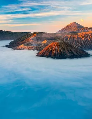 The volcano Mount Bromo in East Java, Indonesia, surrounded by morning mist at sunrise