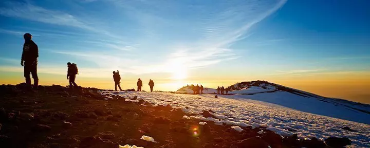 trekkers on Kilimanjaro at sunrise